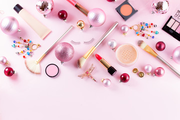 Festive make up products border on pink background