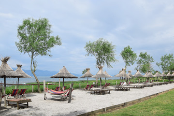 Straw umbrellas on the Lake Skadar beach. Albania - Montenegro border.