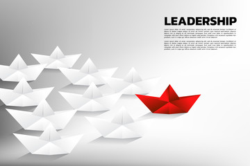 Red origami paper ship leading the group of white. Business Concept of team leadership.
