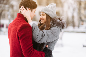Fototapeta premium A young guy and a girl are hugging each other
