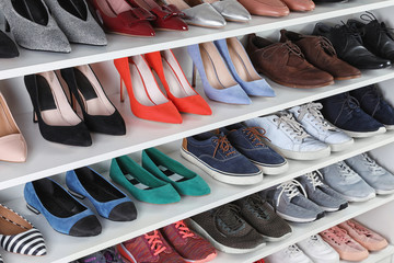 Shelving unit with different shoes. Element of dressing room interior - obrazy, fototapety, plakaty