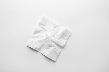 Crumpled paper napkin on white background, top view