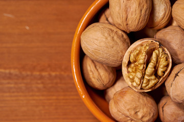 Walnut on brown wooden background. Selective focus