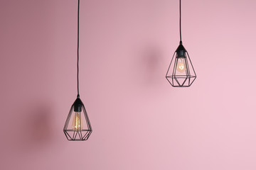 Modern hanging lamp on color background. Idea for interior design