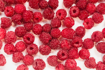 Dripping frash raspberry on the white background.