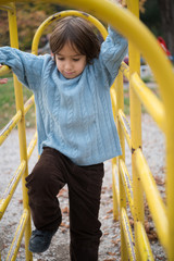 Fototapeta premium cute little boy having fun in playground