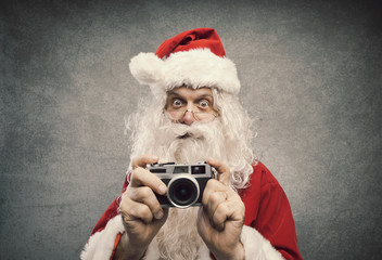 Santa Claus taking holiday pictures