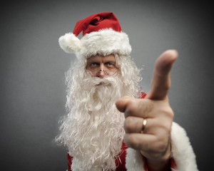 Fototapeta na wymiar Disappointed Santa pointing his finger at you