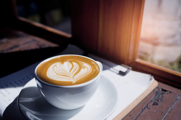 hot latte art coffee on wood table, relax time