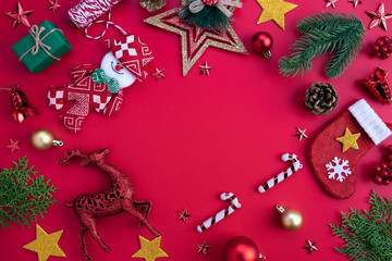 Christmas background concept. Top view of Christmas green and red gift box with spruce branches, pine cones, red berries and bell on white background.