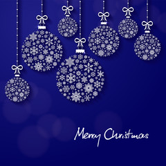 Greeting card with the words Merry Christmas. From above, stylish snowflake-shaped baubles hang on ribbons