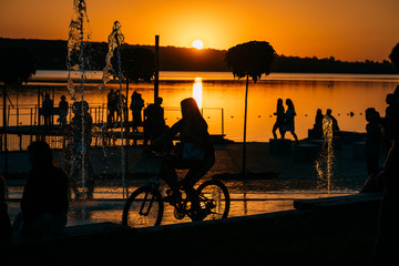 people spend leisure time on the river bank