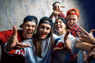 group of excited crazy rappers posing to the camera. hobby, people, free time concept. challenge