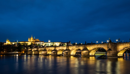 Prague, Czech Republic. Charles Bridge and Hradcany (Prague Castle) with St. Vitus Cathedral and St. George church evening dusk, Bohemia landmark in Praha.