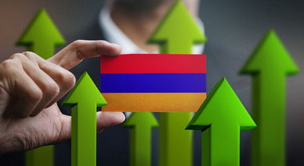 Nation Growth Concept, Green Up Arrows - Businessman Holding Card of Armenia Flag