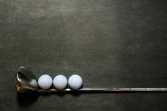 golf ball and golf club on black background