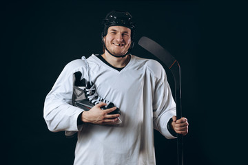 Naklejka premium Emotional hockey player looking at camera skate and gaming stick . Isolated on black
