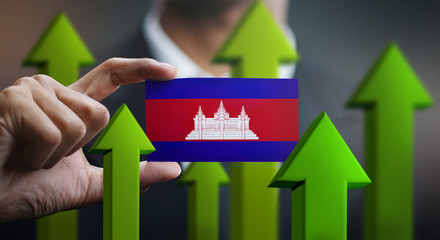 Nation Growth Concept, Green Up Arrows - Businessman Holding Card of Cambodia Flag