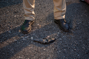 Detective at the crime scene. A man stands over the victim's body. Crime
