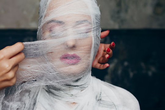 Glamorous mummy.Beautiful glamorous woman with makeup, fully bandaged, wrapped in bandages face