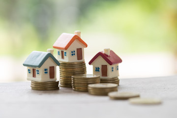 Mini house on stack of coins,Money and house, Real estate investment, Save money with stack coin, Mortgage concept.