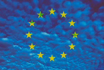 European flag on a blue sky background with a clouds texture. Europe  flags with a yellow stars on skies.