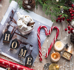 Christmas decor: Warm sweater, cup of hot cocoa with marshmallow, candy, candles, Christmas tree. Winter mood, Cozy Home