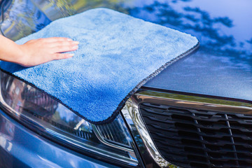 car cleaning with microfiber towel close up