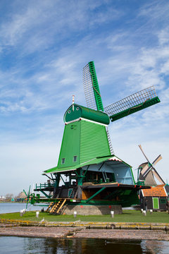 Landscape of well-preserved historic windmills and houses