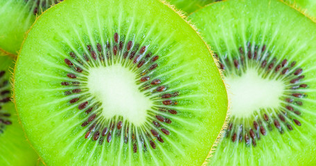 Fresh kiwi fruit slices closeup macro background