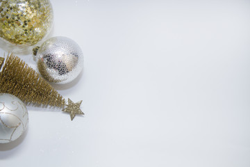 Christmas toy, a lot of brilliant balls of golden, silver color and golden tree. New Year. On a gray background, top view..