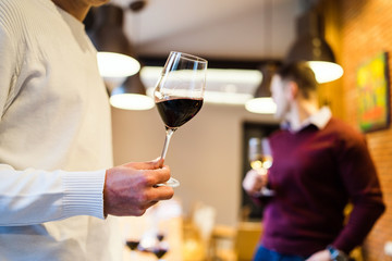 waiter serving red wine in restaurant