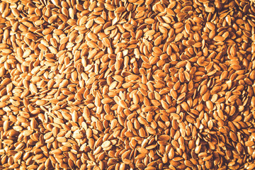 Flax seed, a lot on the whole background. Linen