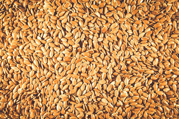 Flax seed, a lot on the whole background. Linen