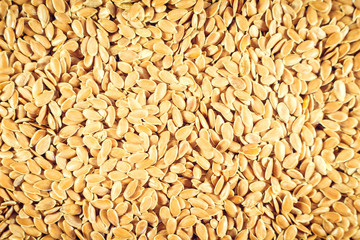 Flax seed, a lot on the whole background. Linen