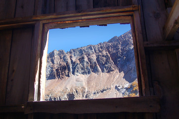 View out the window of abandoned mining shack of the mountains above the Rico Silverton trail in the San Juan range of the Colorado Rockies.