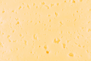 Cheese with holes yellow-white close-up in the whole photo