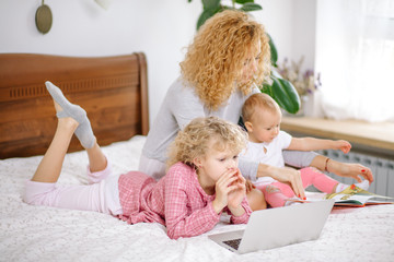Fototapeta premium holidays with children. useful time with kids. woman terying to give knowledge to her children. side view photo