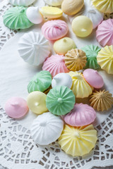 Colorful meringue cookies on napkin, natural light selective focus