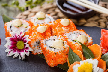 Sushi Rolls - Maki Sushi sashimi decorated with flowers. Japanese cuisine. Selective focus