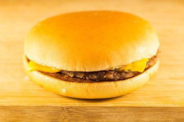 Burger fast food with meat, cheese and salad.