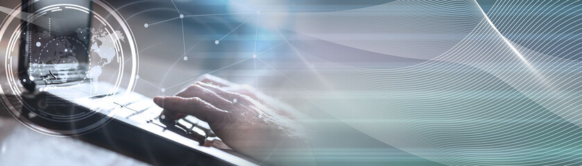 Hands using a laptop, hard light effect, overlayed with graph. panoramic banner