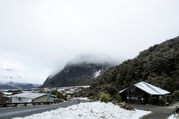 View of a road in Mount Cook Village covered with white fresh snow after a snowy day.