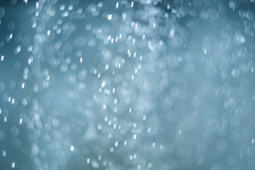 Obraz premium falling snow, abstract blue bokeh background