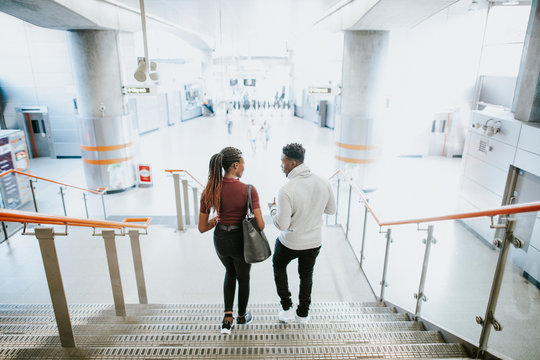 Friends walking down the stairs into the subway station