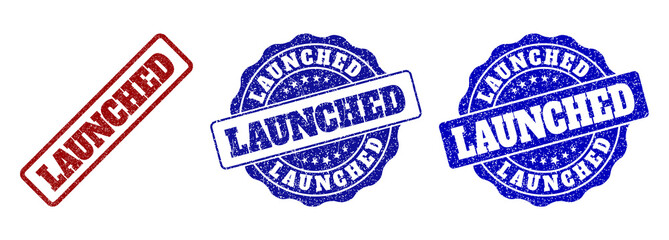 LAUNCHED grunge stamp seals in red and blue colors. Vector LAUNCHED labels with grunge surface. Graphic elements are rounded rectangles, rosettes, circles and text captions.