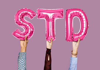 Hands holding STD word in balloon letters - obrazy, fototapety, plakaty