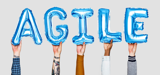 Hands holding agile word in balloon letters