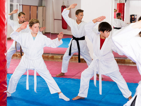 Kids in kimonos practicing effective karate techniques