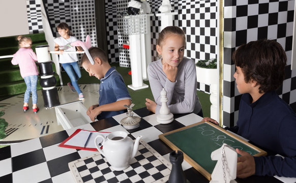 children look for a way out inin quest room in chess style